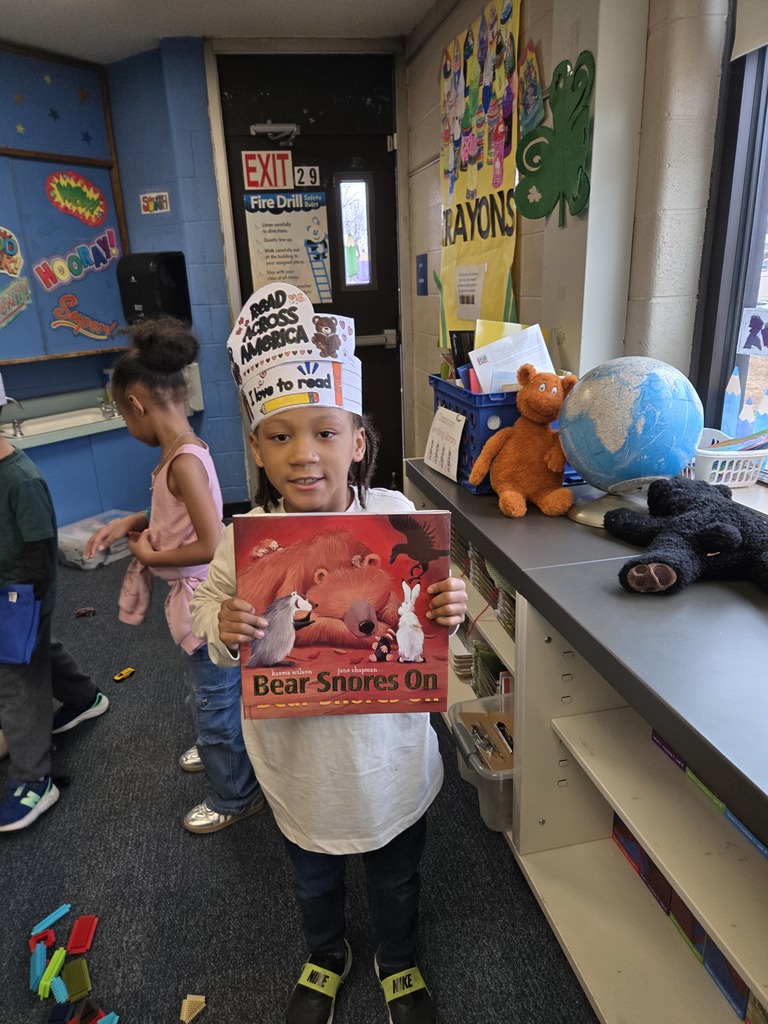 A student holding his new book from the book giveaway