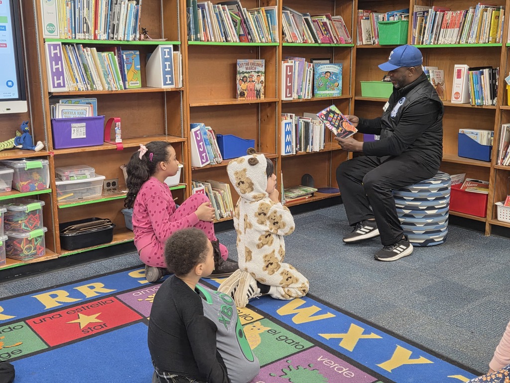 Students being read to by a guest reader