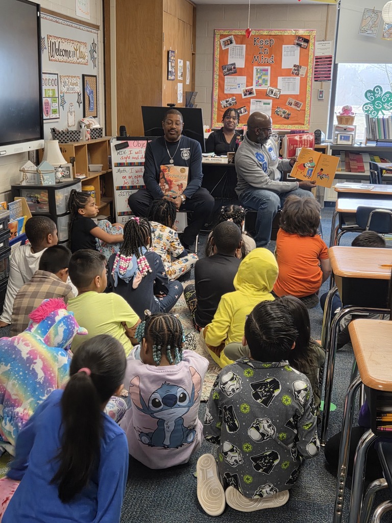 Students being read to by guest readers