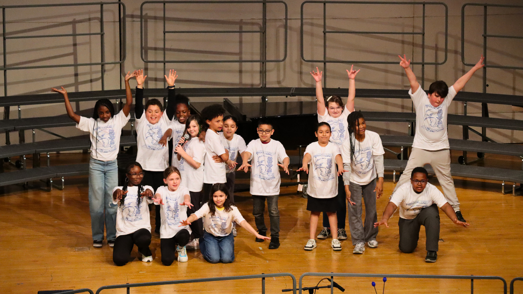 Small group of elementary students performing on stage.