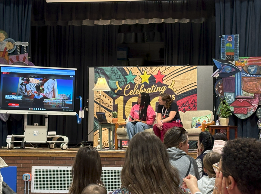 Staff and families at the Black History Month Celebration watching a video