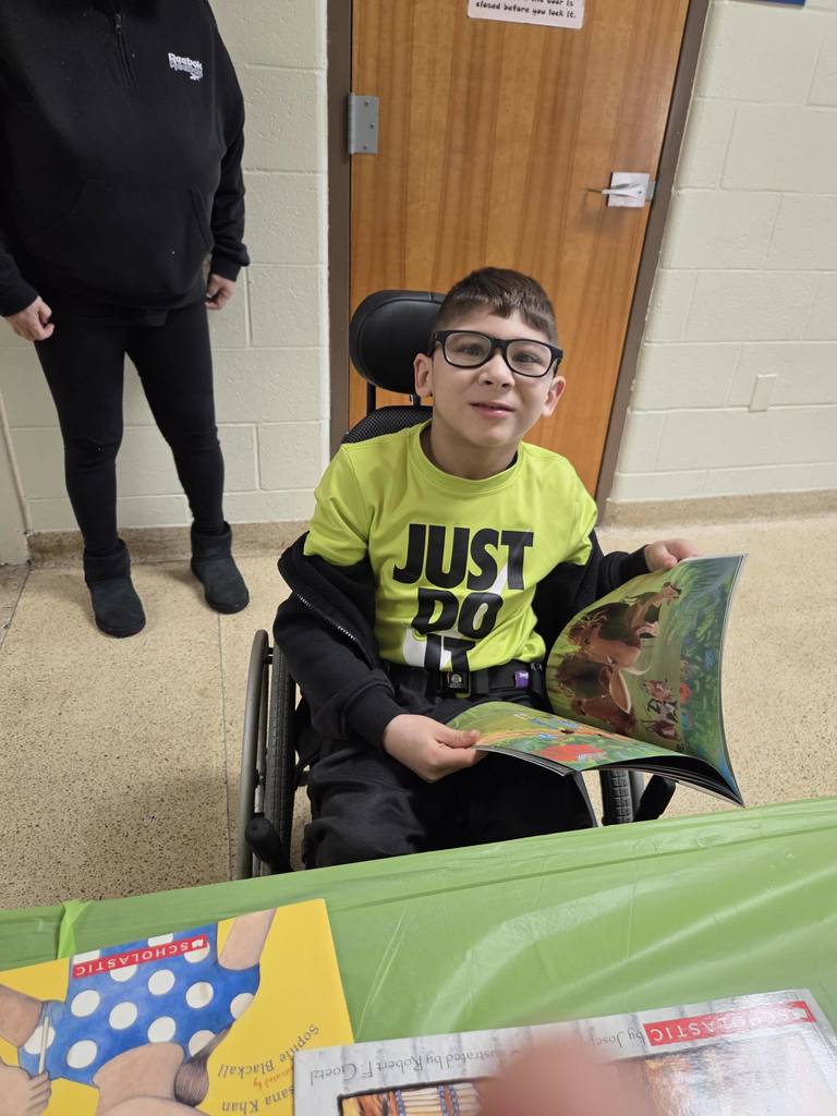 A student selects a new book through the RIF program.