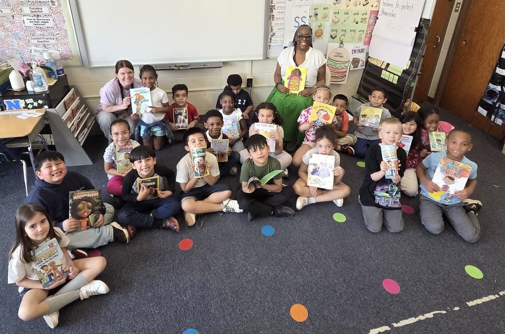 Students show their new RIF book.