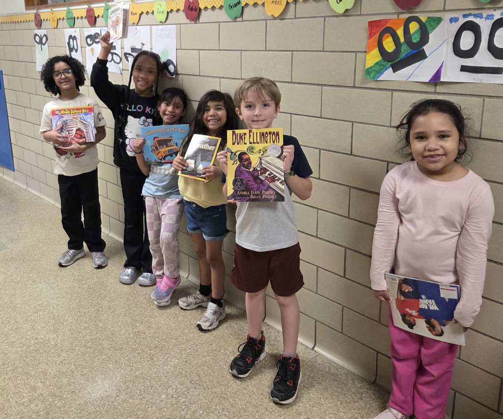 Students show their new RIF book.