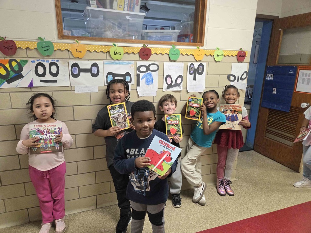 Students show their new RIF book.