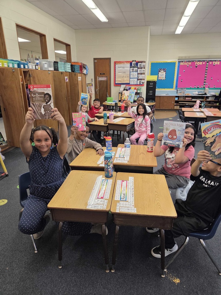 Students show their new RIF book.