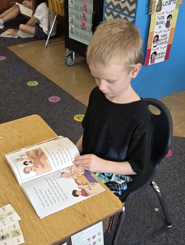 A student reads his new RIF book.