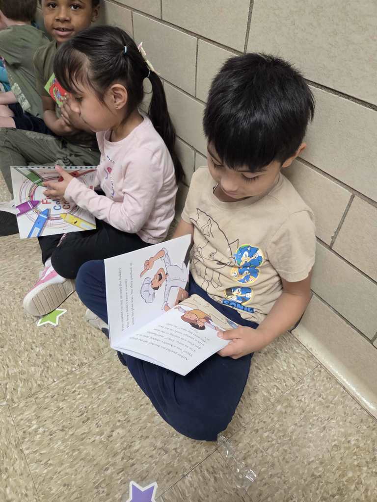 Students read their new RIF books.