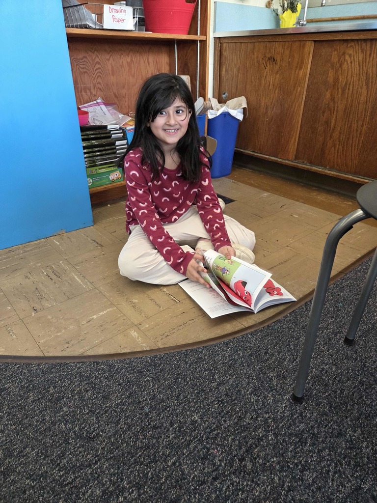 A student reads her new RIF book.