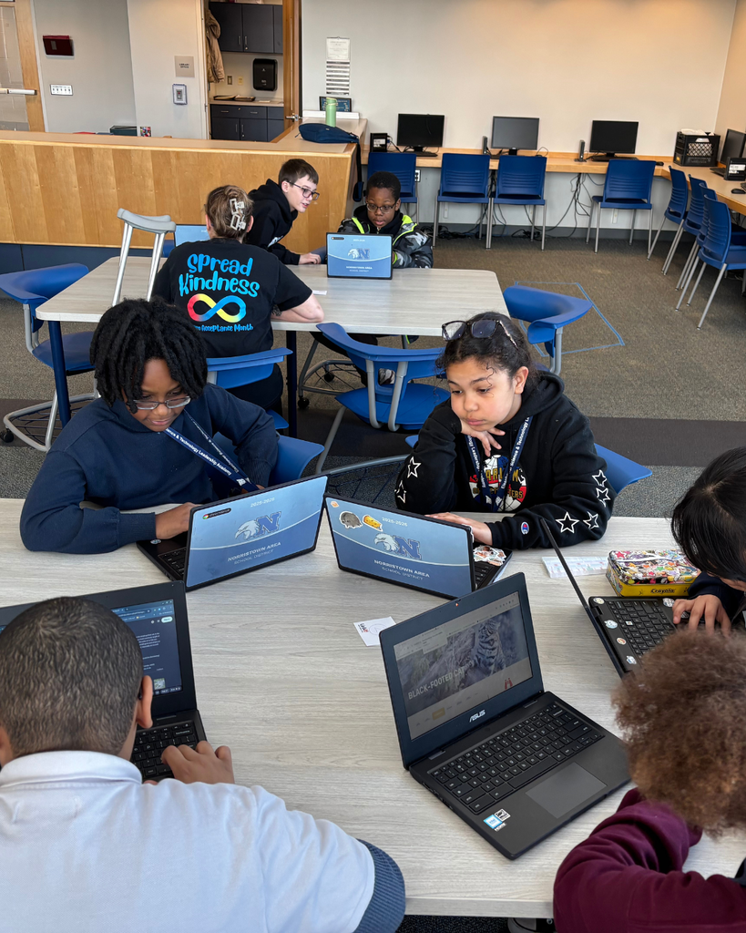 Small group of studnets working on their Dream It, Design It project with their Chromebooks.