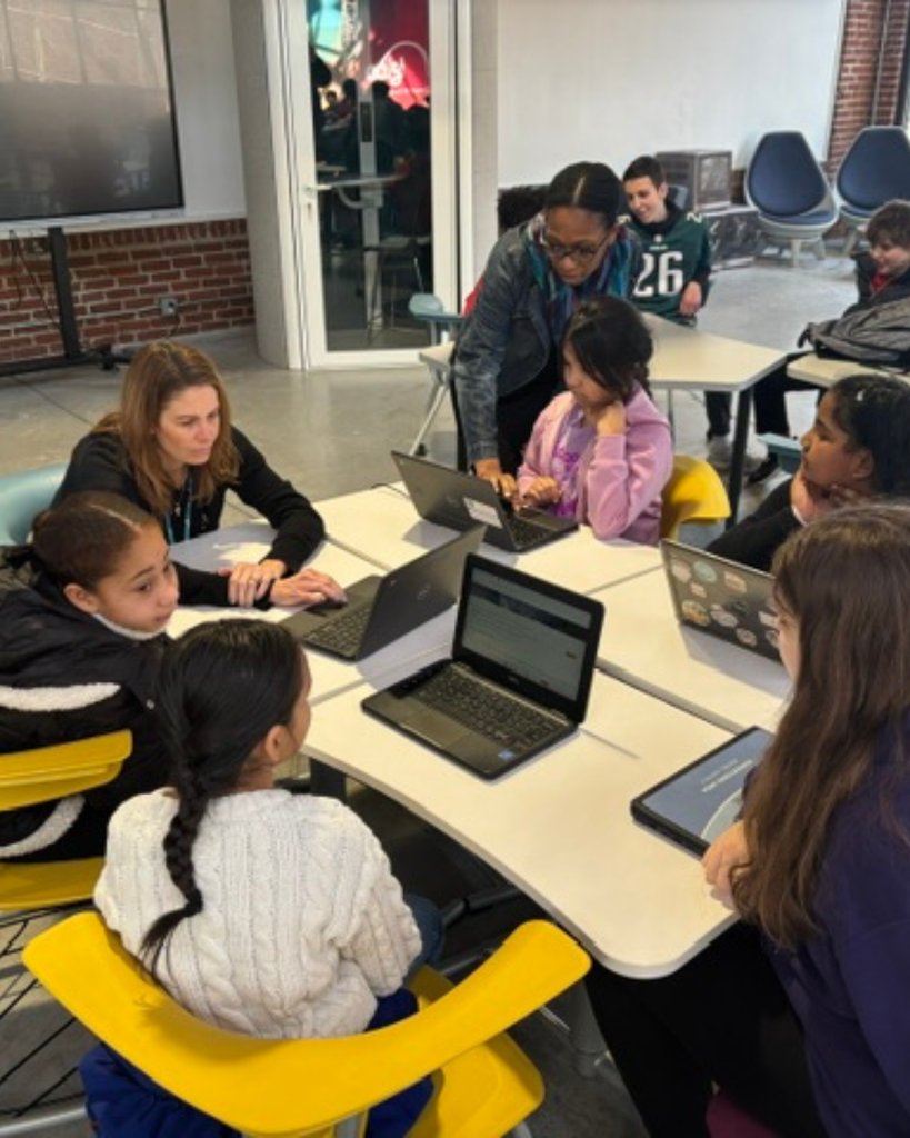 Large group of studnets working on their Dream It, Design It project with their Chromebooks.