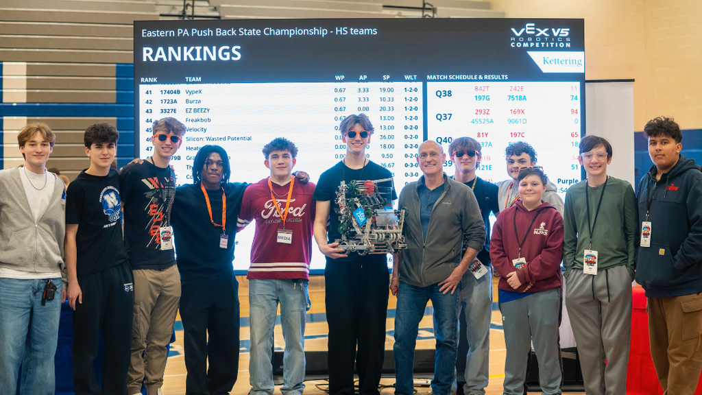 NASD high school and middle school robotics tea pose for a photo with State Representative Joe Webster. 