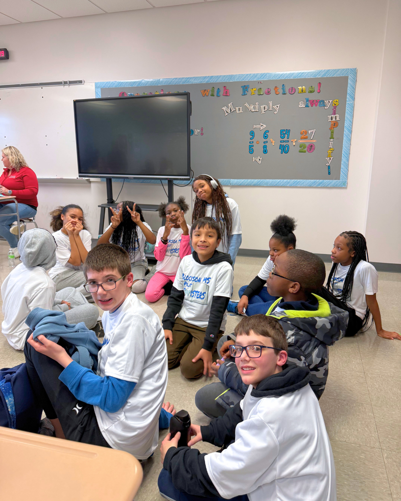 Blockson students sitting on the floor smiling for a photo. 