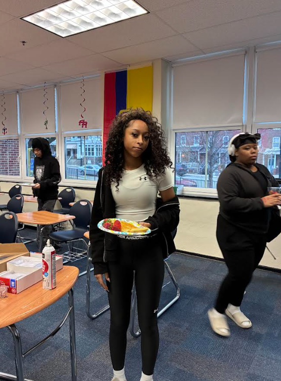 A student is standing with her waffle