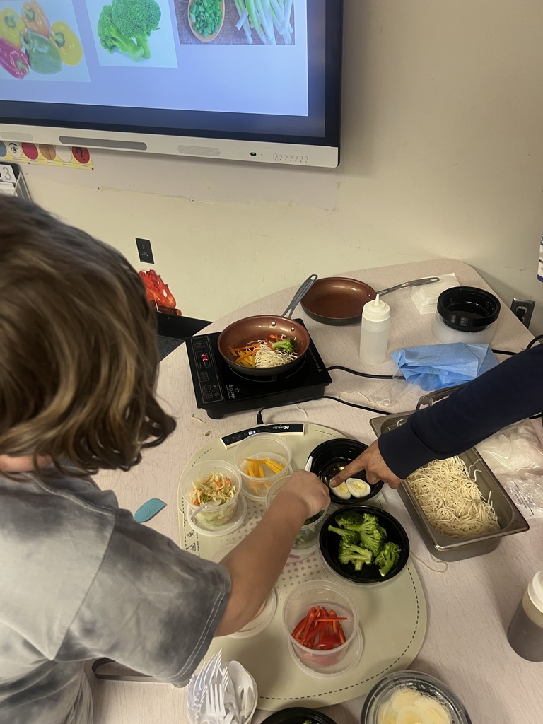 Chef Jamela B. cooking with a student.