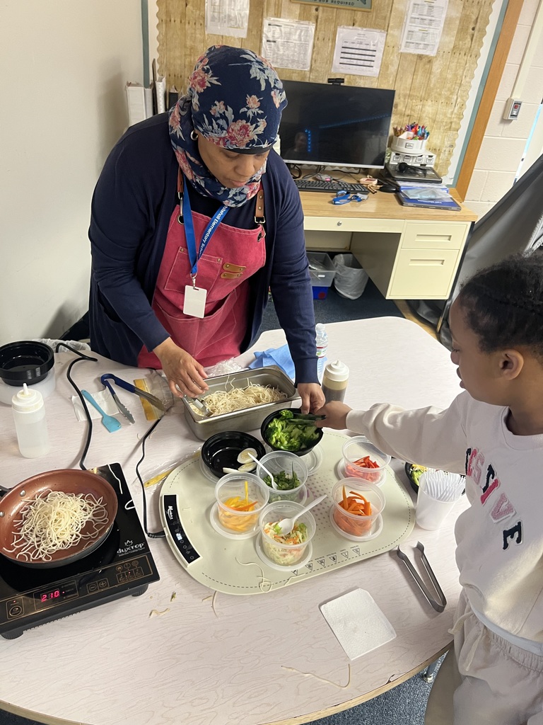 Chef Jamela B. cooking with a student.