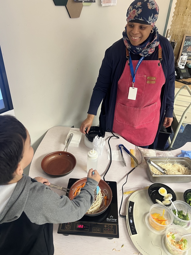 Chef Jamela B. cooking with a student.