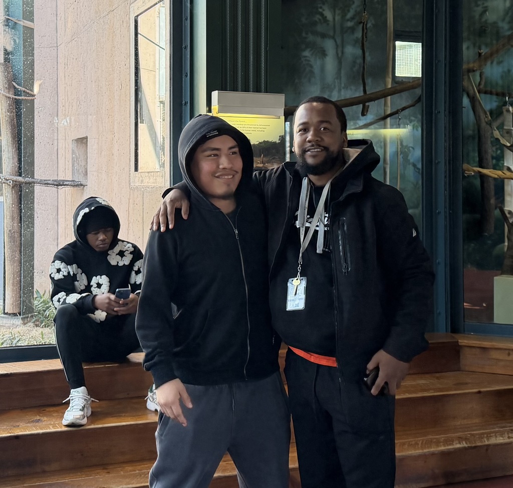 A student and teacher are posing together