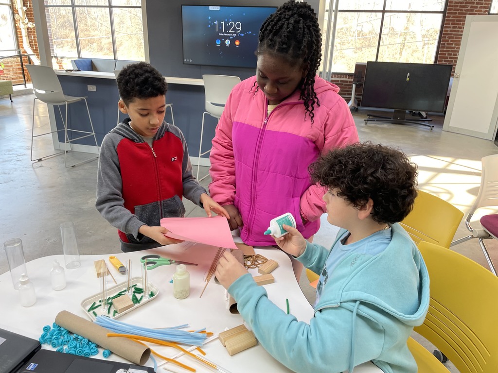 A group of students working together at “Dream It, Design It” competition 