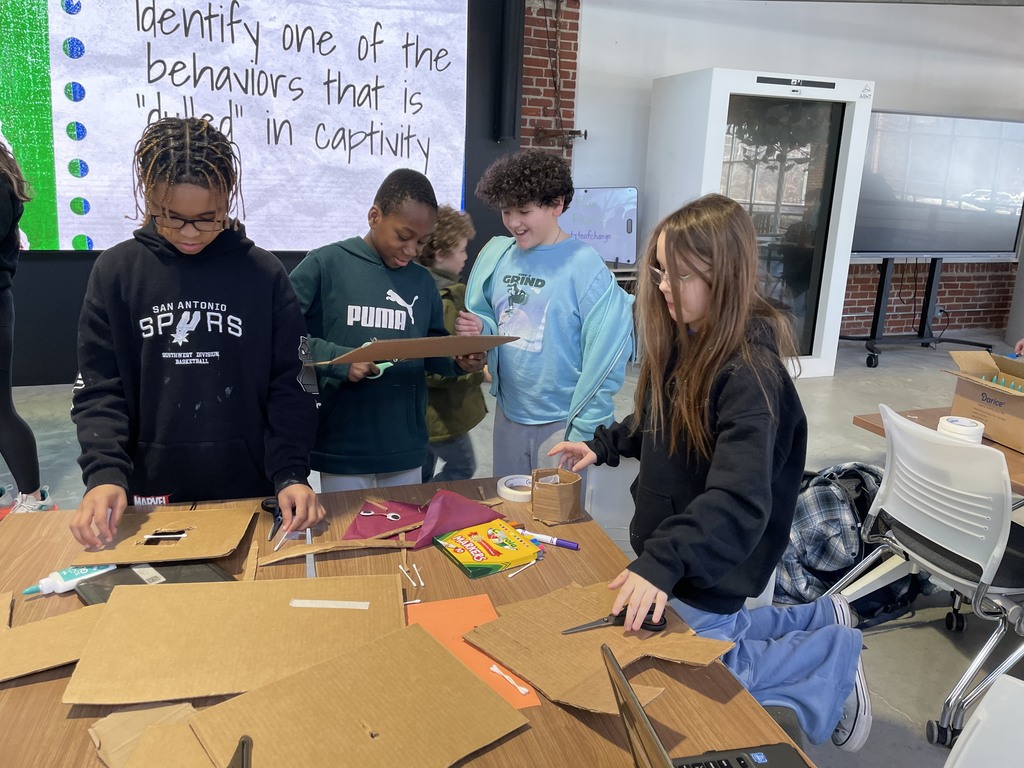 A group of students working together  at “Dream It, Design It” competition 