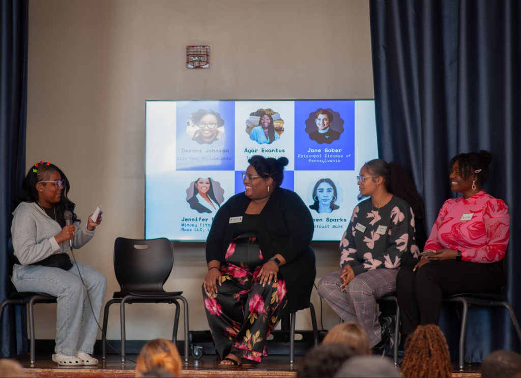 A student is running a panel discussion