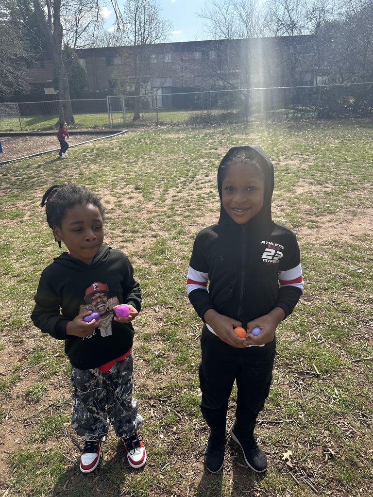 Kindergarteners participate in an egg hunt on the playground.