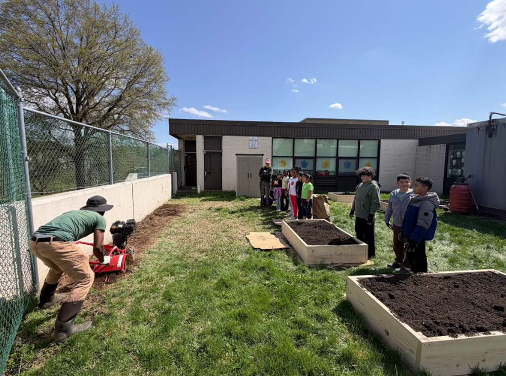 Students outside preparing the gardens