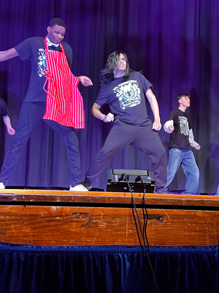Students are dancing on the stage at NAHS for the pageant