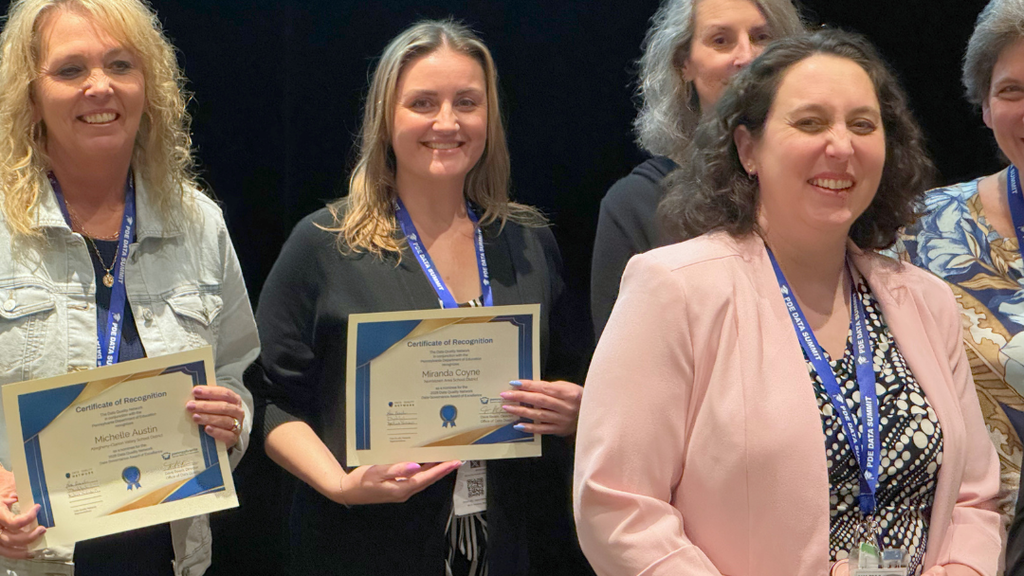 Miranda Coyne poses for photo with certificate. 