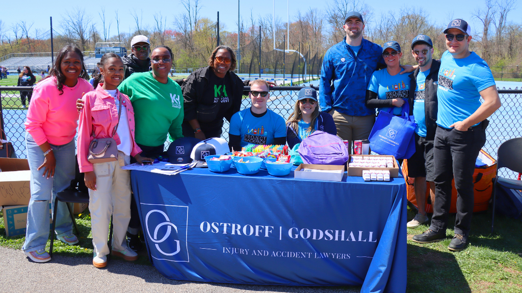 Community partners pose for group photo behind their table. 