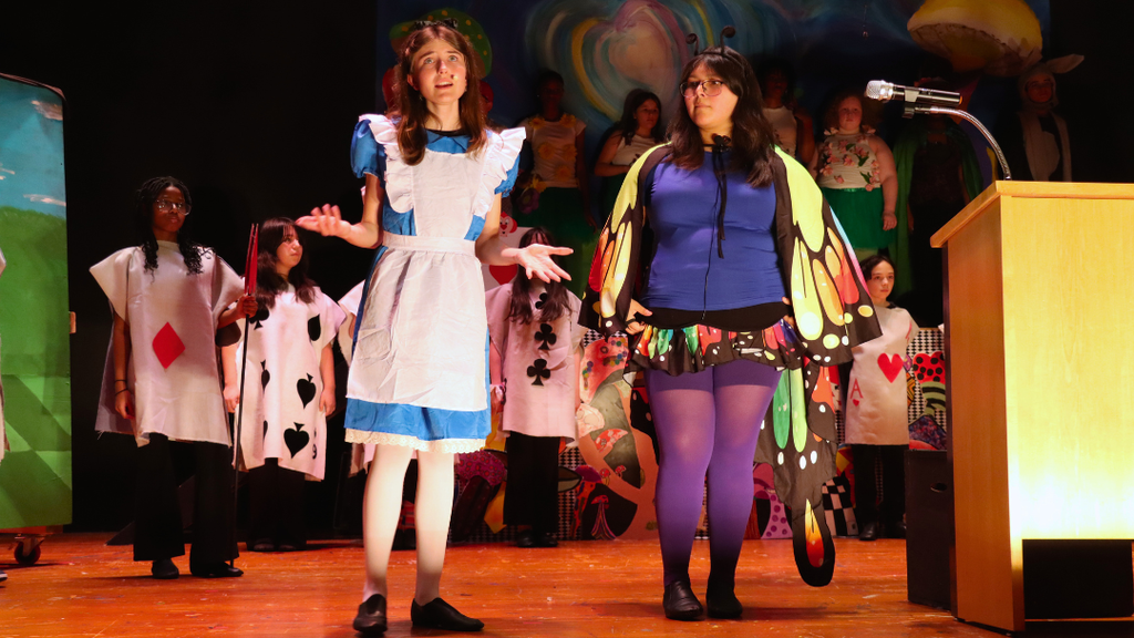 Students performing on stage.