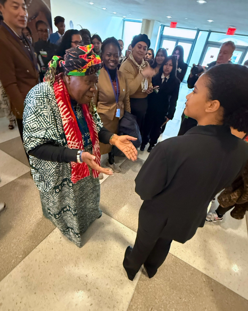 Student speaking with Queen Mother Dr. Delois Blakely