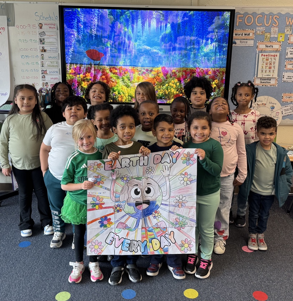 First graders in Mrs. Bowen's class show their Earth Day poster.