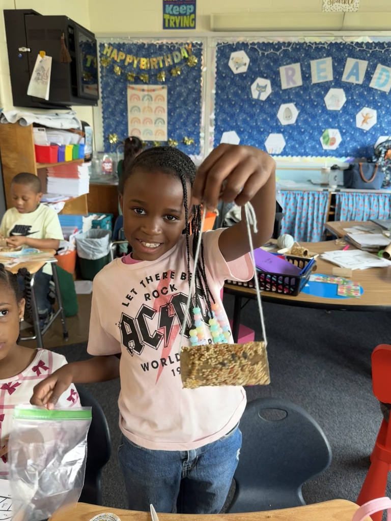 First graders in Mrs. Bowen's class make bird feeders with recycled materials.
