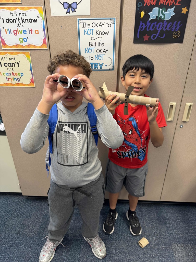 Students show their projects made of recycled materials.