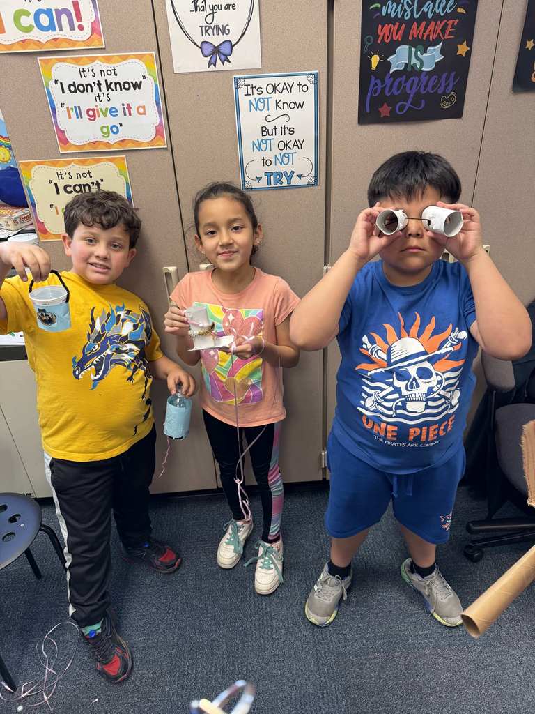 Students show their projects made of recycled materials.