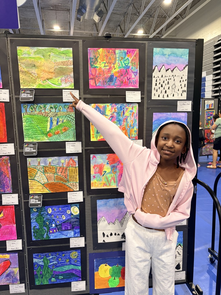 A Hancock student showing off their artwork.