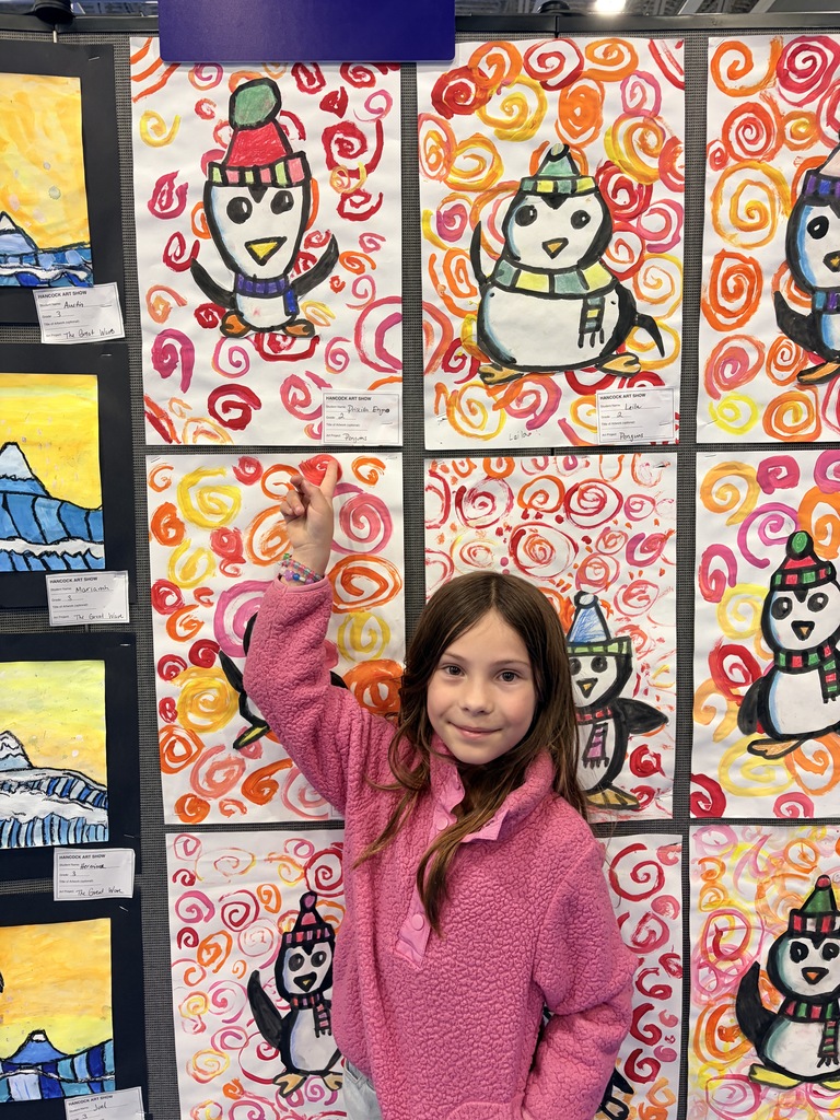 A Hancock student showing off their artwork.