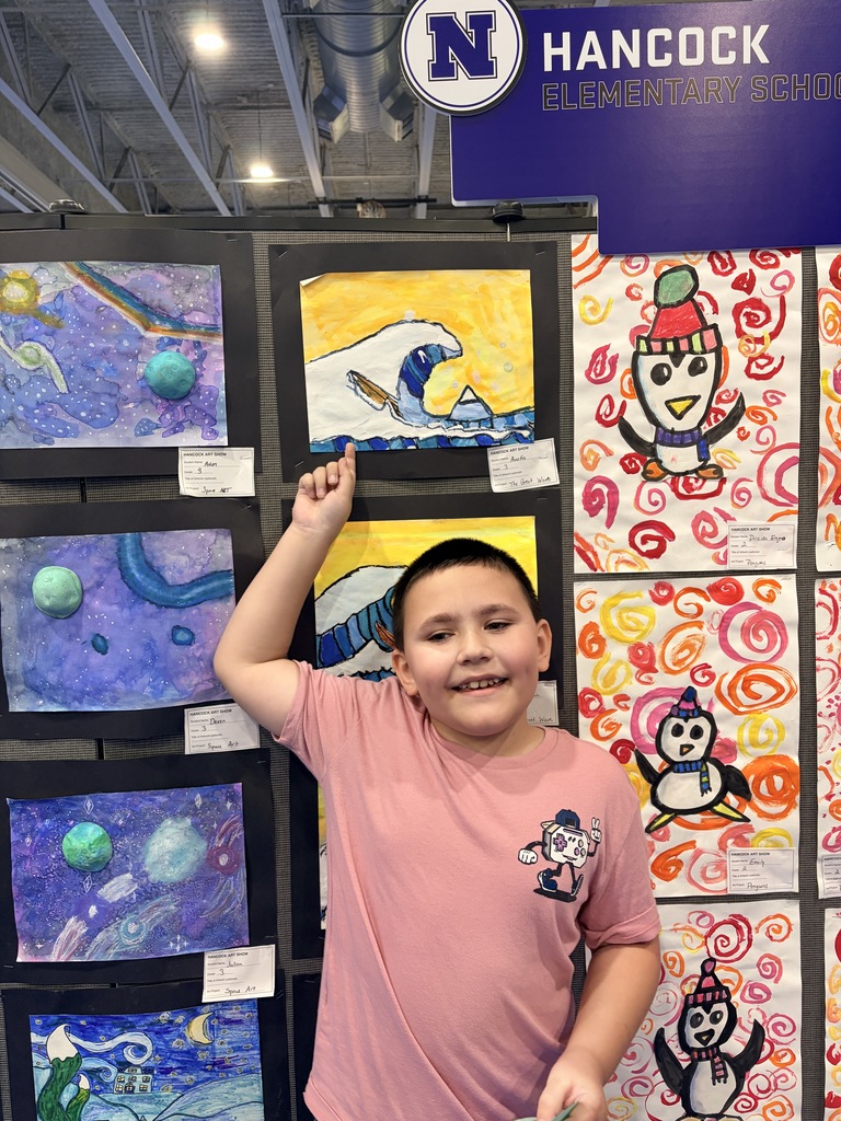 A Hancock student showing off their artwork.