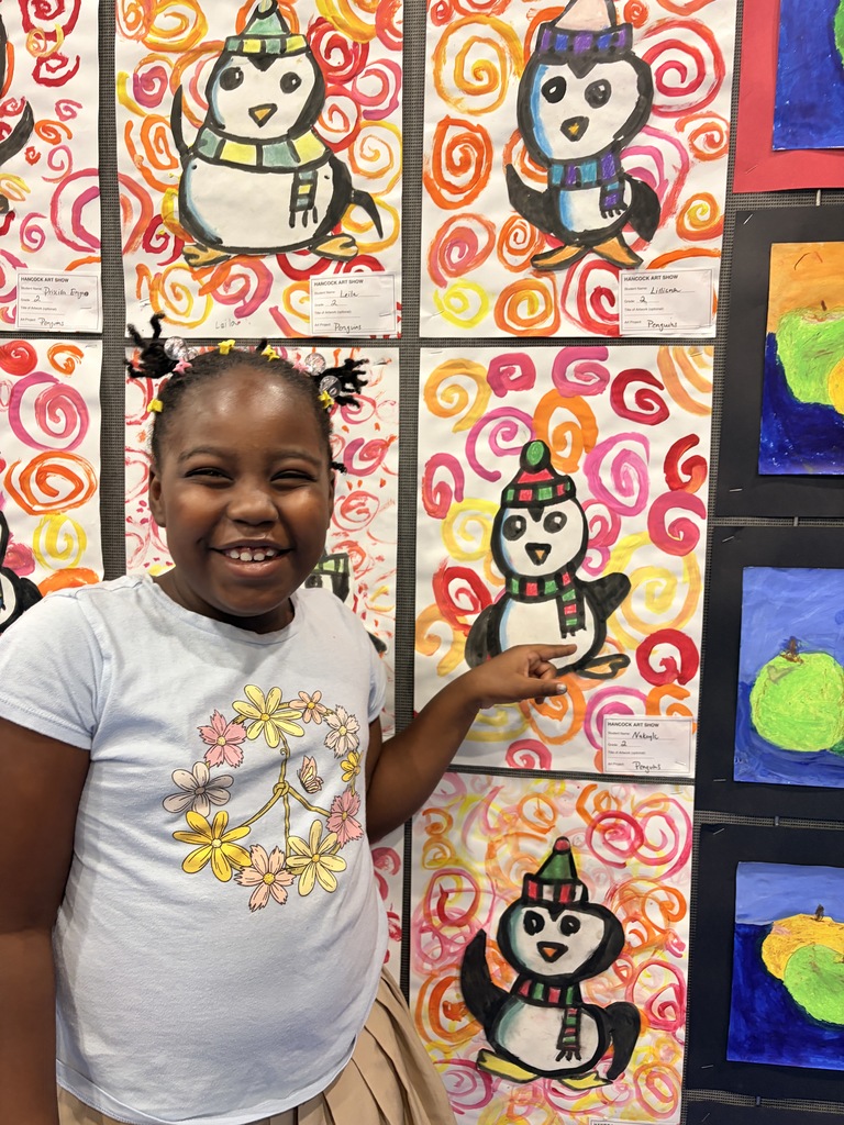 A Hancock student showing off their artwork.