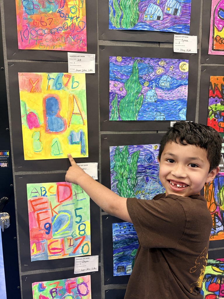 A Hancock student showing off their artwork.