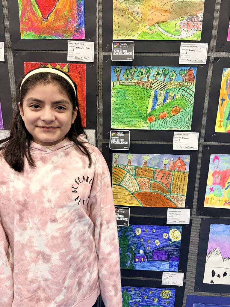 A Hancock student showing off their artwork.