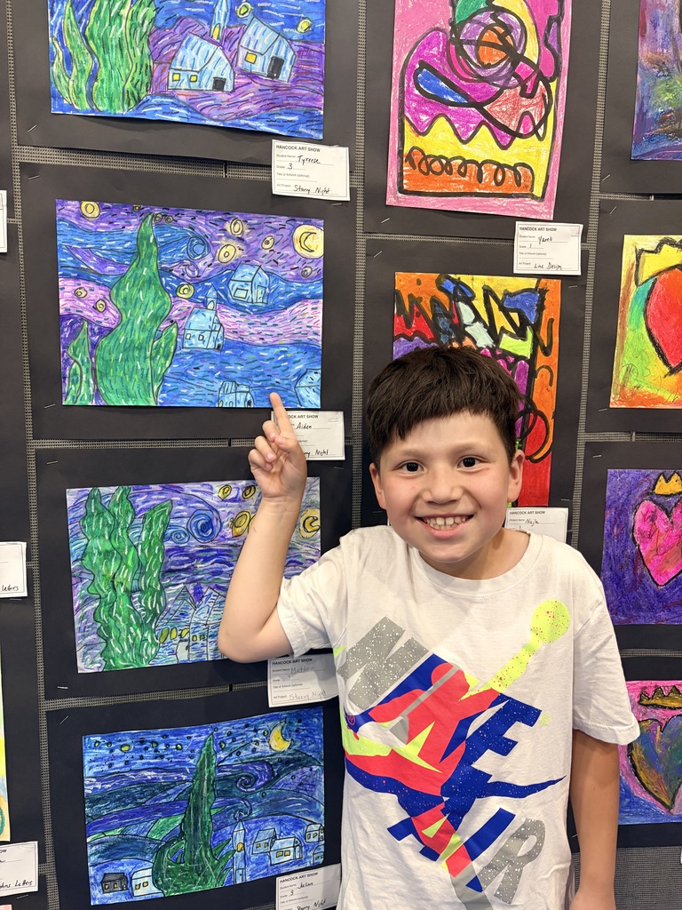 A Hancock student showing off their artwork.