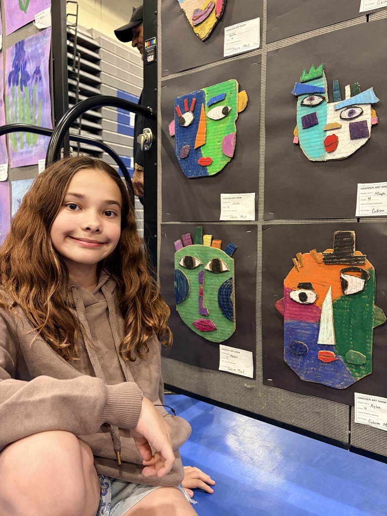 A Hancock student showing off their artwork.
