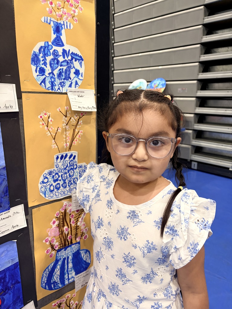A Hancock student showing off their artwork.