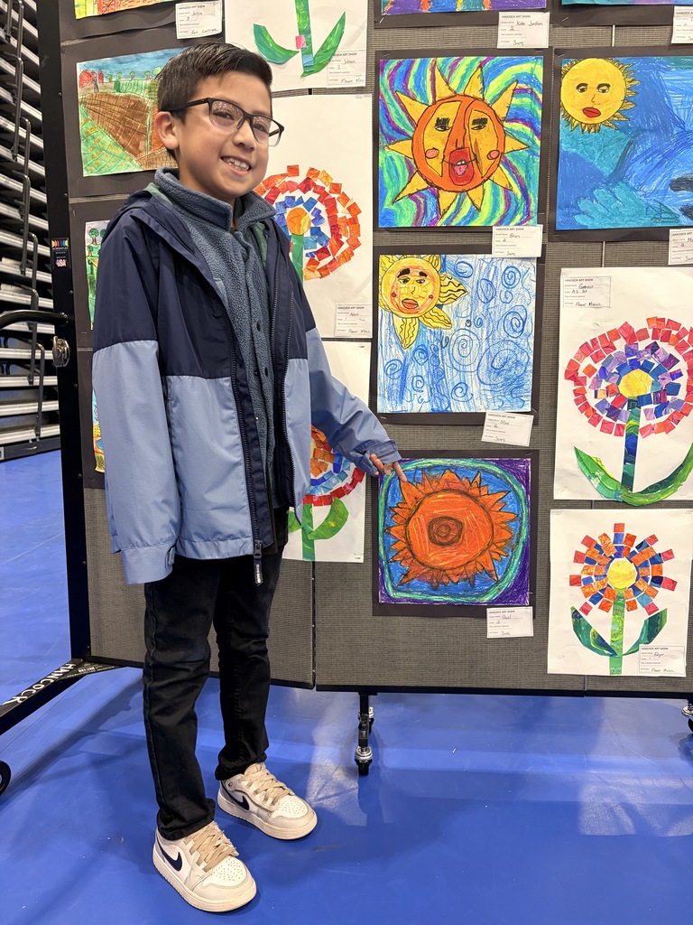 A Hancock student showing off their artwork.