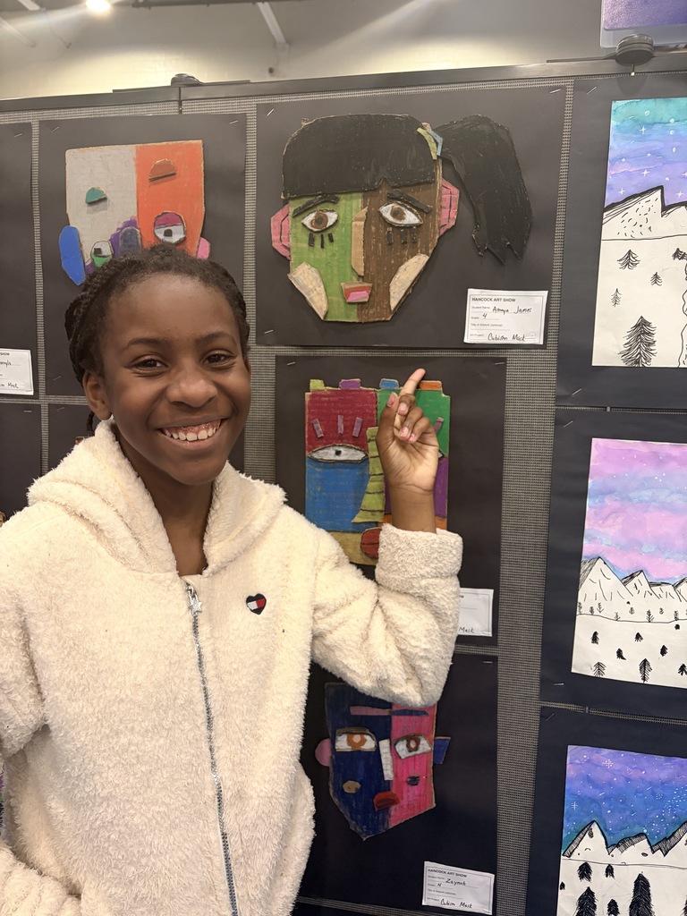 A Hancock student showing off their artwork.