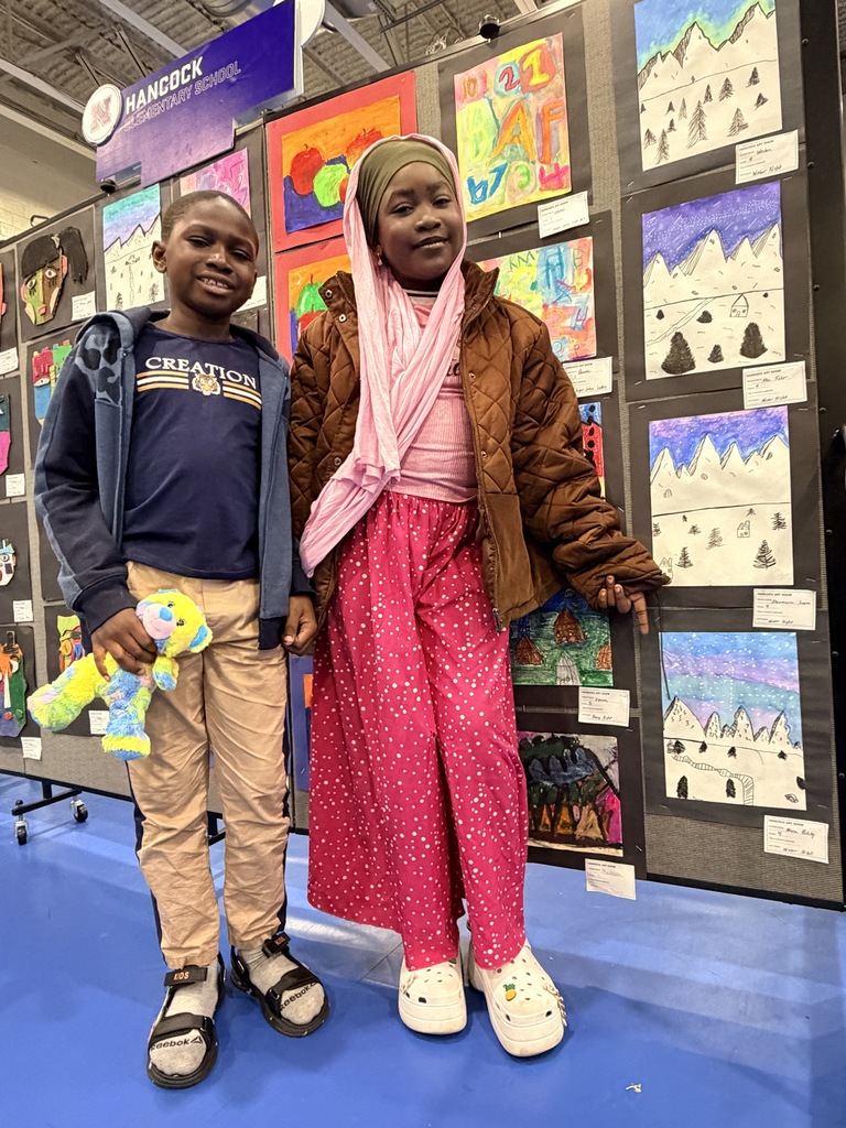 A Hancock student showing off their artwork.