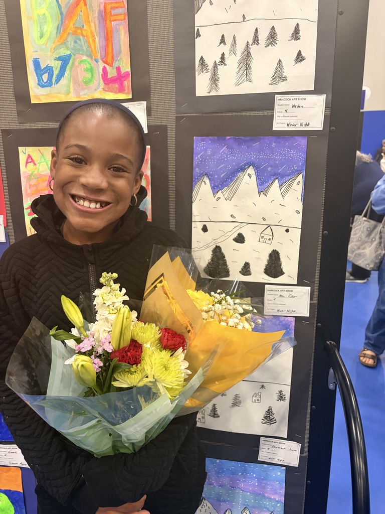 A Hancock student showing off their artwork.