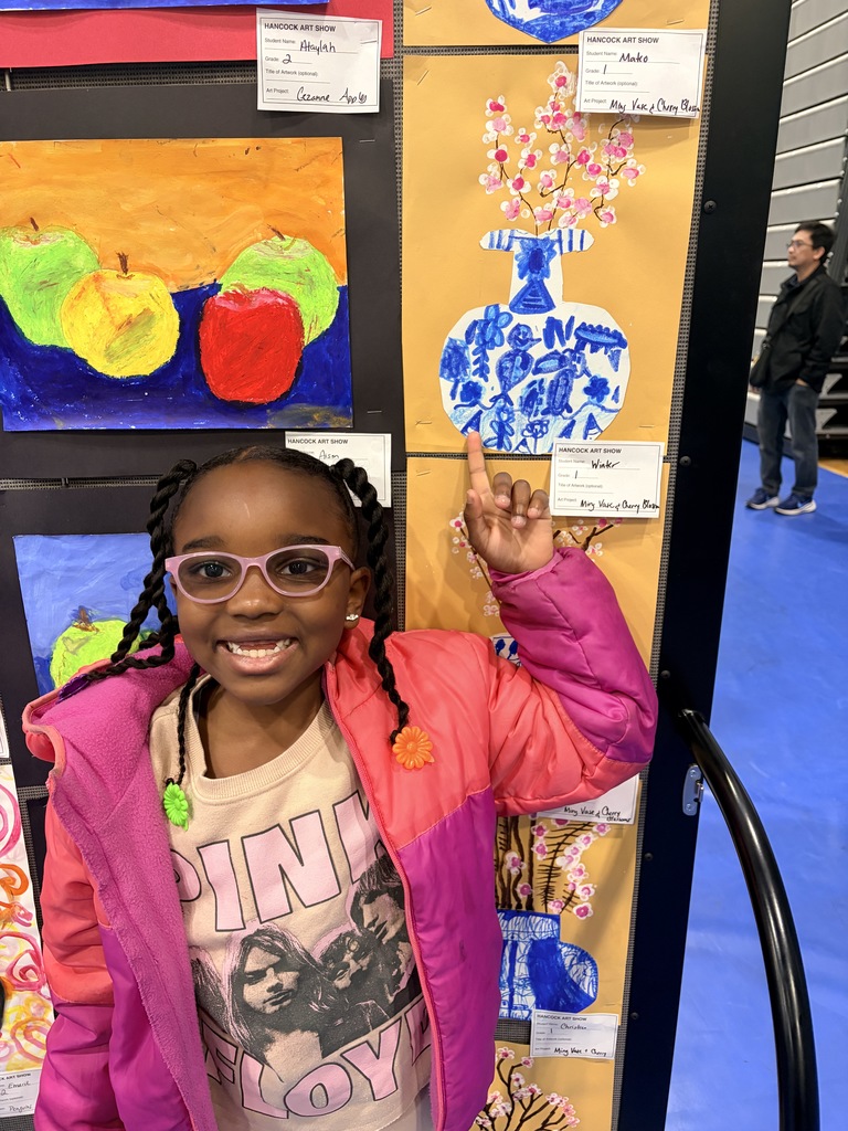 A Hancock student showing off their artwork.